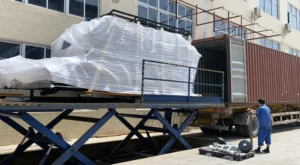 Ecocampor caravan being loaded into a shipping container at the factory for export to Australia